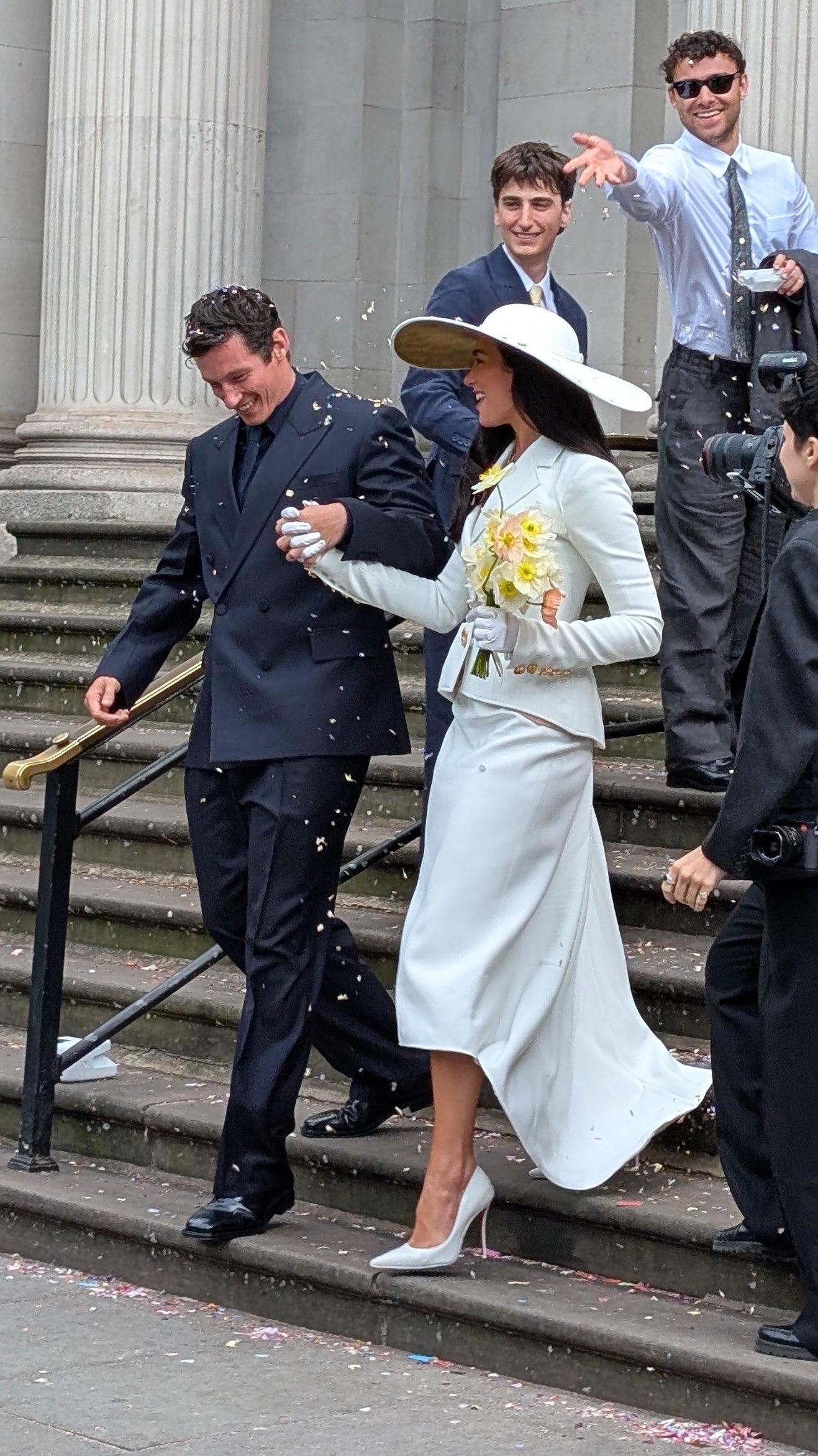 Dua Lipa and Callum Turner walk down the town hall steps after their wedding
